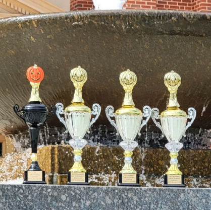 Pumpkin Decorating Contest trophies placed infront of the Edmon Low Library fountain