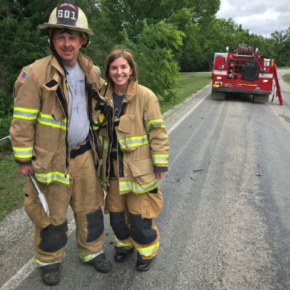 Student helping the Stillwater Firefighters
