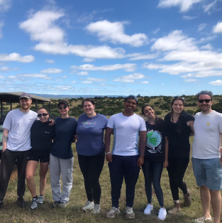 Group of students smiling outside